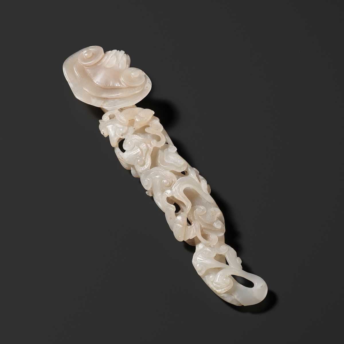 Lot 170 - A RETICULATED WHITE JADE RUYI IN THE FORM OF A LINGZHI WITH BATS, QING DYNASTY