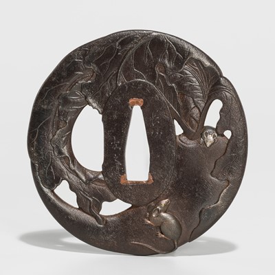 Lot 202 - TOMOYUKI: A FINE CHOSHU SCHOOL IRON SUKASHI TSUBA DEPICTING RATS ON A DAIKON (RADISH)