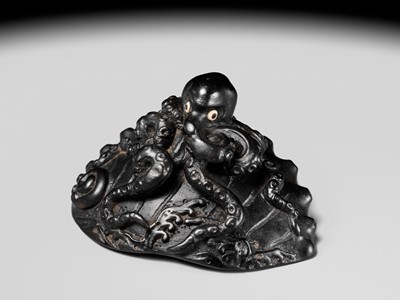 Lot 181 - YASUTSUGU: A LARGE EBONY WOOD NETSUKE OF AN OCTOPUS ON AN AWABI SHELL