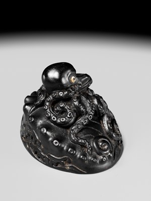 Lot 181 - YASUTSUGU: A LARGE EBONY WOOD NETSUKE OF AN OCTOPUS ON AN AWABI SHELL