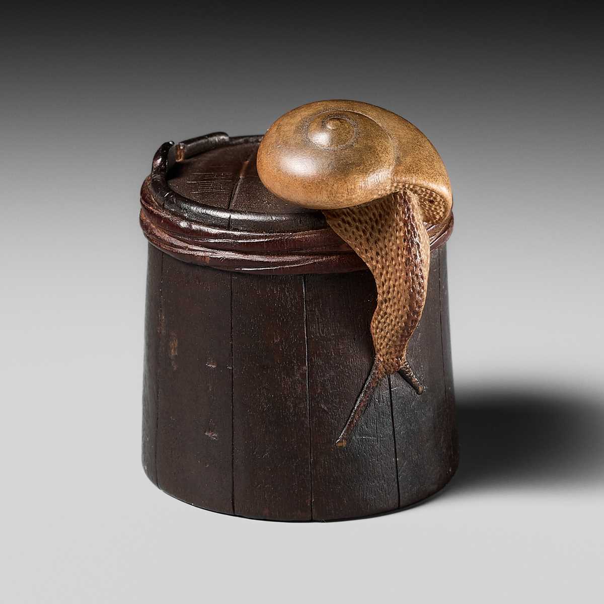 Lot 174 - SHIGEMASA: A SUPERB WOOD NETSUKE OF A SNAIL ON BUCKET