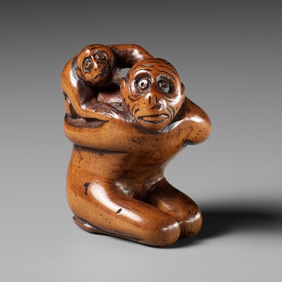 Lot 46 - AN EARLY WOOD NETSUKE OF A MONKEY WITH YOUNG