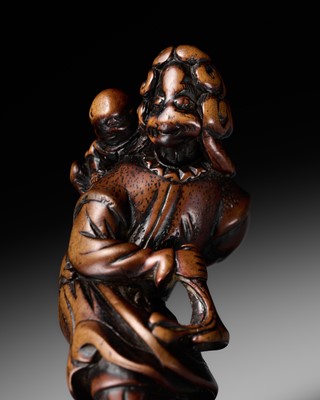 Lot 72 - A TALL WOOD NETSUKE OF A DUTCHMAN WITH CHILD