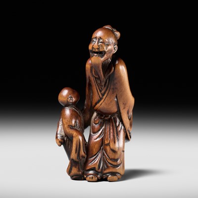 Lot 74 - AN OLD WOOD NETSUKE OF A CHINESE SAGE AND DISCIPLE