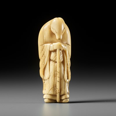 Lot 61 - A FINE IVORY NETSUKE OF A FOX PRIEST (HAKUZOSU)