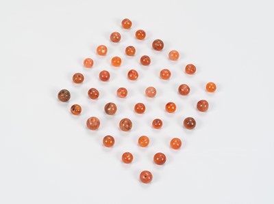 Lot 1158 - A LOT WITH 36 SOUTHEAST ASIAN CARNELIAN AGATE BEADS, 7TH – 12TH CENTURY