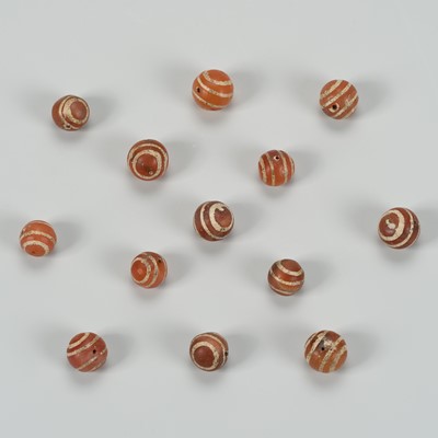 Lot 1117 - A LOT WITH 13 PYU CARNELIAN AGATE BEADS, 7TH-9TH CENTURY