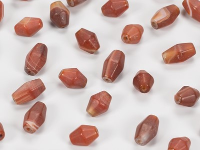 Lot 1142 - A LOT WITH 34 PYU CARNELIAN AGATE BEADS, 7TH-9TH CENTURY