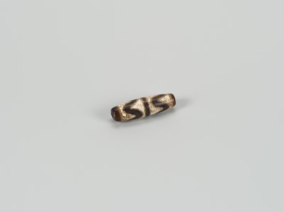 Lot 1520 - A TIBETAN AGATE ‘CHUNG DZI’ BEAD, 19th CENTURY
