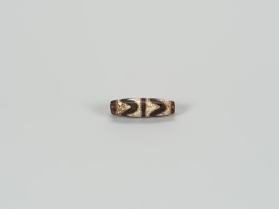 Lot 1520 - A TIBETAN AGATE ‘CHUNG DZI’ BEAD, 19th CENTURY