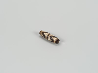 Lot 1520 - A TIBETAN AGATE ‘CHUNG DZI’ BEAD, 19th CENTURY