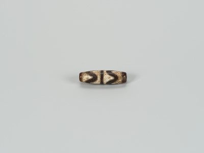 Lot 1520 - A TIBETAN AGATE ‘CHUNG DZI’ BEAD, 19th CENTURY