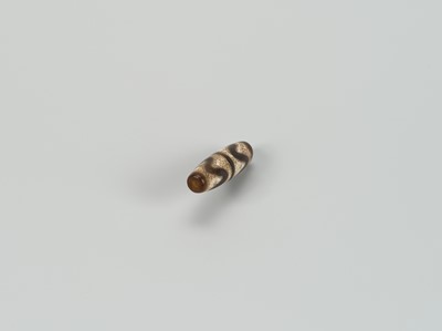 Lot 1520 - A TIBETAN AGATE ‘CHUNG DZI’ BEAD, 19th CENTURY