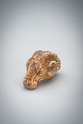 Lot 1422 - A SMALL BACTRIAN STONE CARVING OF A GOAT HEAD