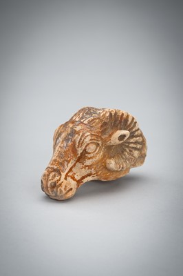 Lot 1422 - A SMALL BACTRIAN STONE CARVING OF A GOAT HEAD