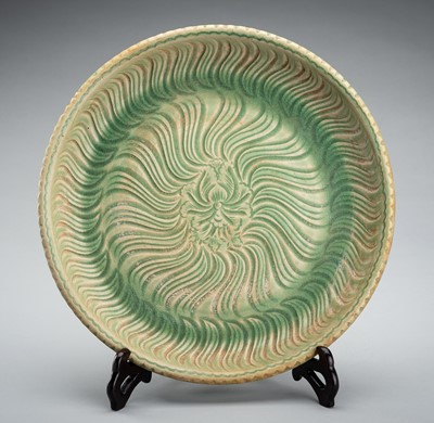 Lot 2099 - A CELADON GLAZED AND CARVED ‘LOTUS’ PORCELAIN CHARGER