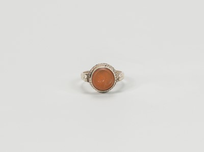 Lot 1318 - A CARNELIAN INTAGLIO INSET PERSIAN SILVER RING