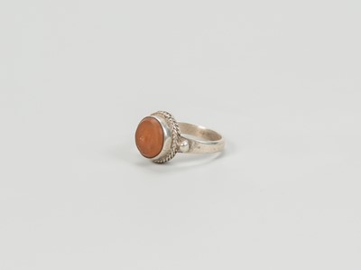 Lot 1318 - A CARNELIAN INTAGLIO INSET PERSIAN SILVER RING