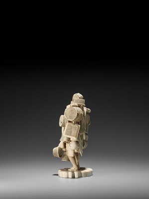 Lot 204 - EISAI: AN IMPRESSIVE IVORY OKIMONO OF A BASKET AND DRUM SELLER