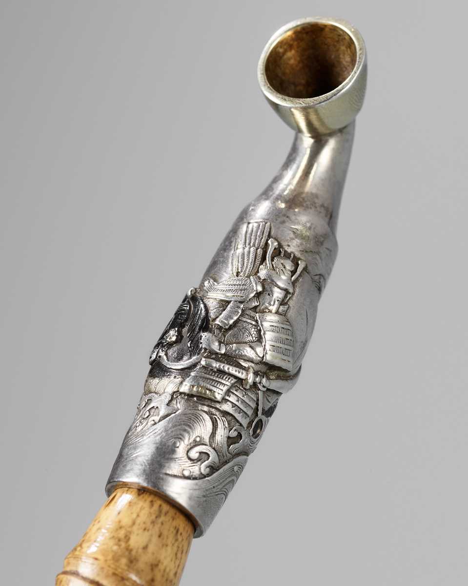 Lot 71 - SHORYUKEN MASATERU: A FINE AND LARGE SILVER AND BAMBOO KISERU (PIPE) DEPICTING THE BATTLE OF UJI