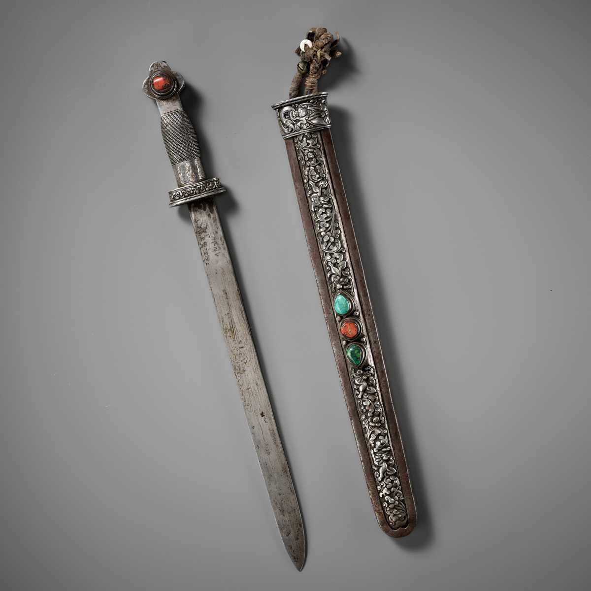 Lot 8 - AN IRON AND SILVER REPOUSSÉ CEREMONIAL SWORD AND SCABBARD