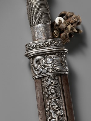 Lot 8 - AN IRON AND SILVER REPOUSSÉ CEREMONIAL SWORD AND SCABBARD