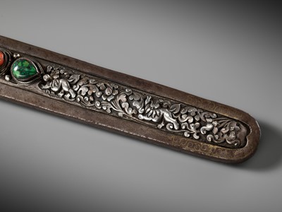 Lot 8 - AN IRON AND SILVER REPOUSSÉ CEREMONIAL SWORD AND SCABBARD