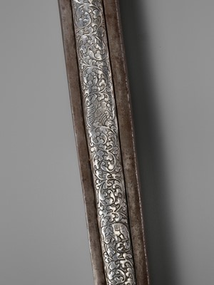 Lot 8 - AN IRON AND SILVER REPOUSSÉ CEREMONIAL SWORD AND SCABBARD