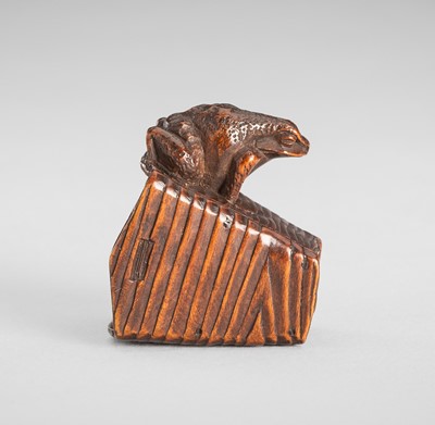 Lot 1649 - MASANAO: A GOOD WOOD NETSUKE OF A FROG ON A BUCKET