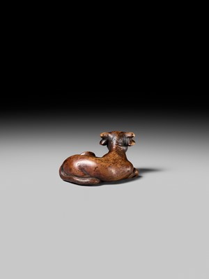 Lot 179 - YUGETSU: A FINE WOOD NETSUKE OF A RECUMBENT OX