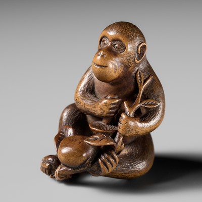 Lot 94 - A FINE WOOD NETSUKE OF A FORAGING MONKEY