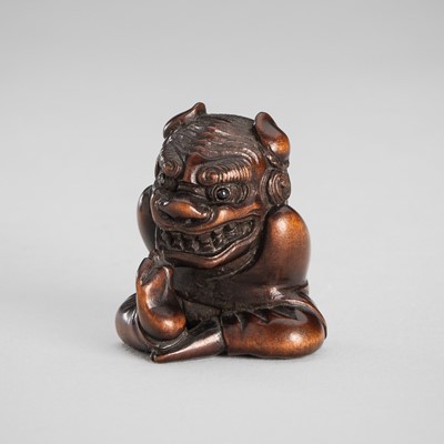 Lot 1587 - A WOOD NETSUKE OF A BOY WITH SHISHIMAI MASK