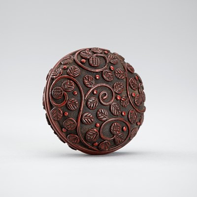 A TSUISHU (CARVED RED LACQUER) MANJU NETSUKE WITH TENDRILS