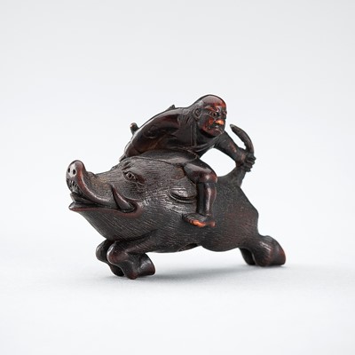 Lot 547 - SHURAKU: A WOOD NETSUKE OF NITTA NO SHIRO RIDING A WILD BOAR