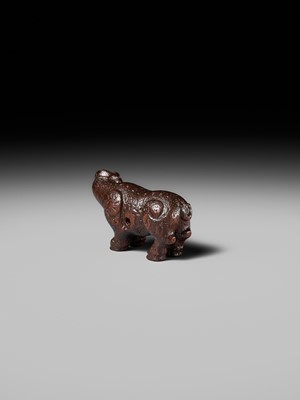 Lot 285 - OUCHI SOSUI: A FINE SO SCHOOL WOOD NETSUKE OF AN ARCHAIC CHINESE BRONZE BUFFALO