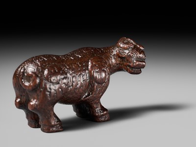 Lot 285 - OUCHI SOSUI: A FINE SO SCHOOL WOOD NETSUKE OF AN ARCHAIC CHINESE BRONZE BUFFALO