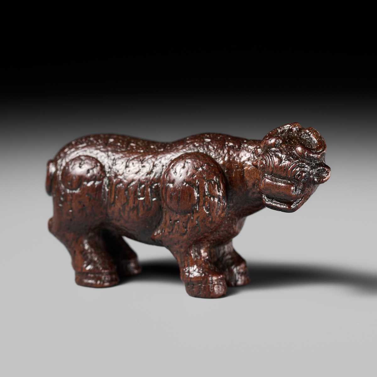 Lot 285 - OUCHI SOSUI: A FINE SO SCHOOL WOOD NETSUKE OF AN ARCHAIC CHINESE BRONZE BUFFALO