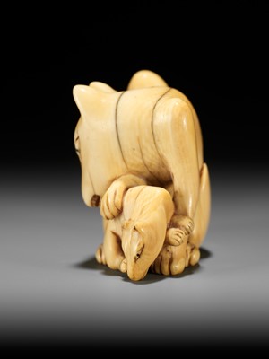 Lot 60 - A RARE IVORY NETSUKE OF A KITSUNE (FOX) AND CUB