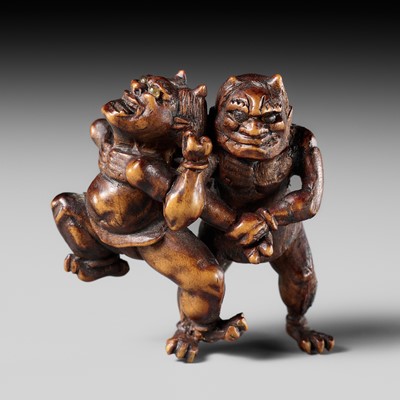 Lot 453 - A FINE WOOD NETSUKE OF TWO WRESTLING ONI