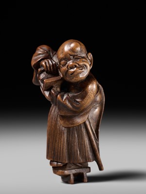 Lot 189 - A FINE WOOD NETSUKE OF A BLIND MAN WITH A STONE IN HIS GETA, ATTRIBUTED TO SHOKO