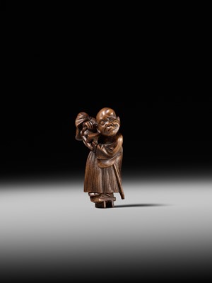 Lot 189 - A FINE WOOD NETSUKE OF A BLIND MAN WITH A STONE IN HIS GETA, ATTRIBUTED TO SHOKO