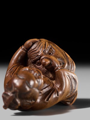 Lot 409 - ONO SHORAKU: A WOOD SHUNGA NETSUKE OF OKAME AND TENGU MASK