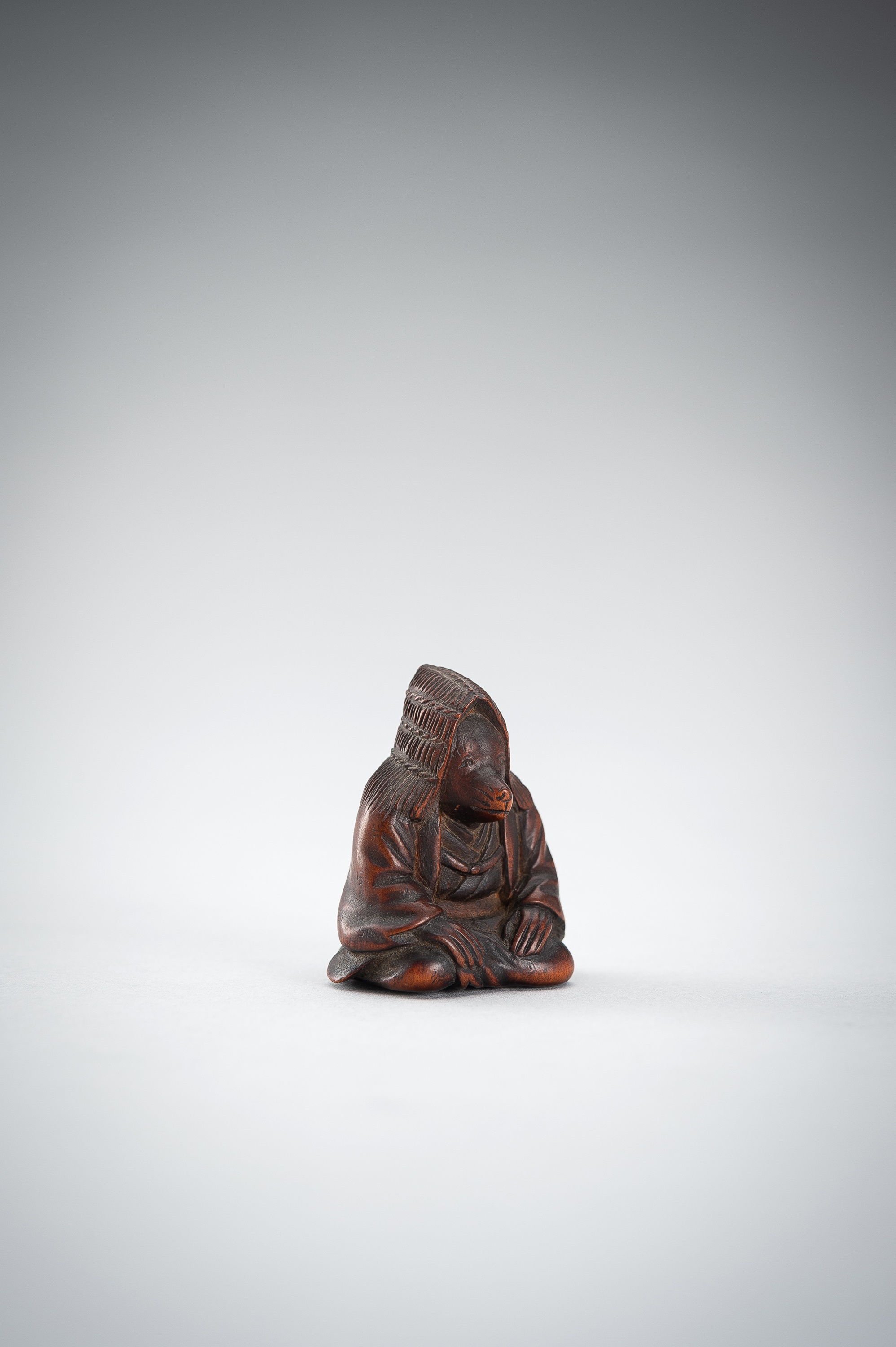 Lot 504 - A WOOD NETSUKE OF A FOX PRIEST (HAKUZOSU)