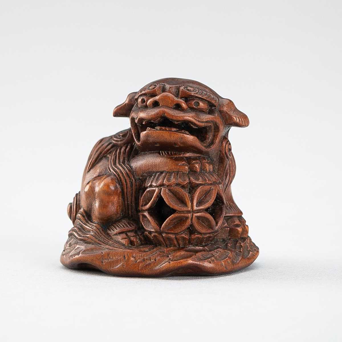 Lot 509 - MINKOKU: A WOOD NETSUKE OF A SHISHI WITH