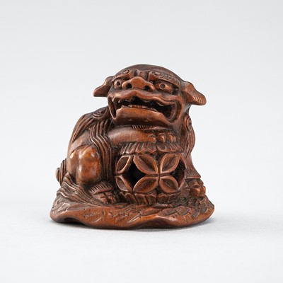 Lot 509 - MINKOKU: A WOOD NETSUKE OF A SHISHI WITH BALL