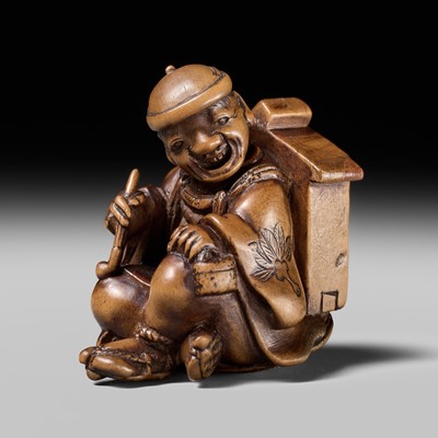 Lot 231 - AN AMUSING WOOD KARAKURI (TRICK) NETSUKE OF A MASK SELLER