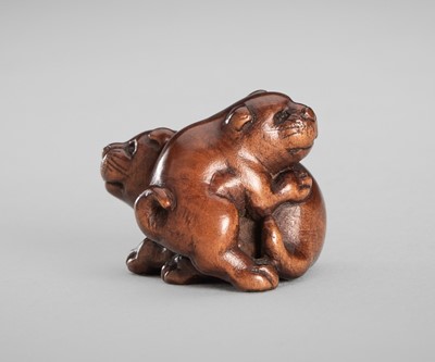 Lot 1545 - KOKEI: A SMALL WOOD NETSUKE OF TWO FROLICKING PUPPIES
