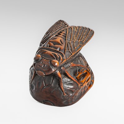 Lot 1580 - A FINE WOOD NETSUKE OF A CICADA ON A WALNUT
