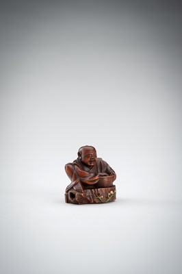Lot 523 - RYUMIN: A WOOD NETSUKE OF HANASAKA-JIJI WITH A BASKET OF ASHES