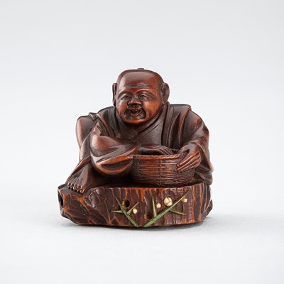 Lot 523 - RYUMIN: A WOOD NETSUKE OF HANASAKA-JIJI WITH A BASKET OF ASHES